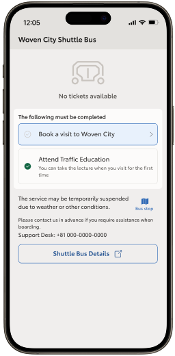 Two smart phones side by side with the left showing the free shuttle bus ticket access screen with an error message and disabled button on a day when the visitor has not reserved to come to Woven City, and the right shows a screen with the "Attend Traffic Education" task checked off, but the "Book a visit to Woven City" unchecked which causes the free shuttle bus ticket access to be disabled