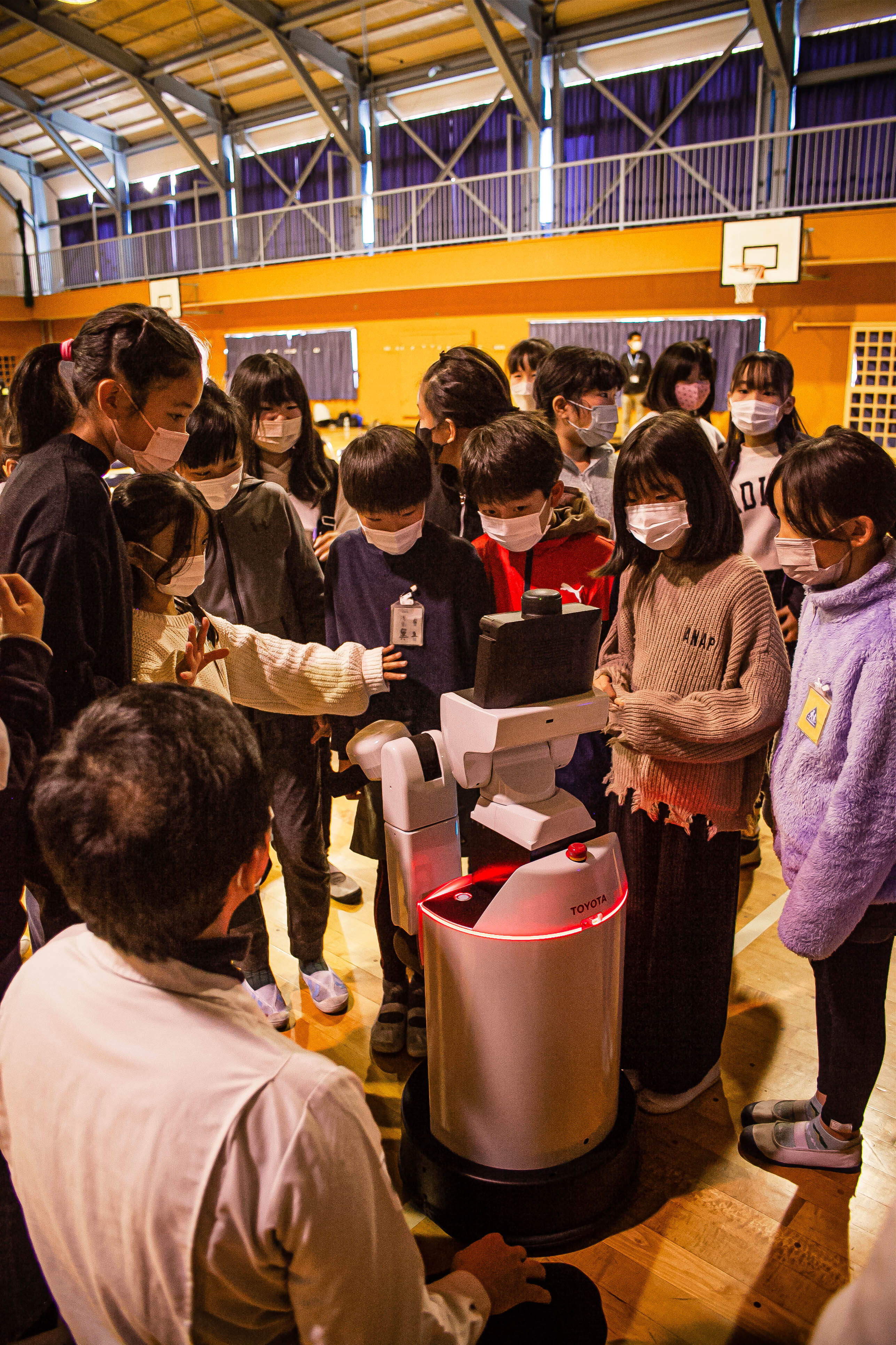 Photo of students trying out the Home Helper Robot
