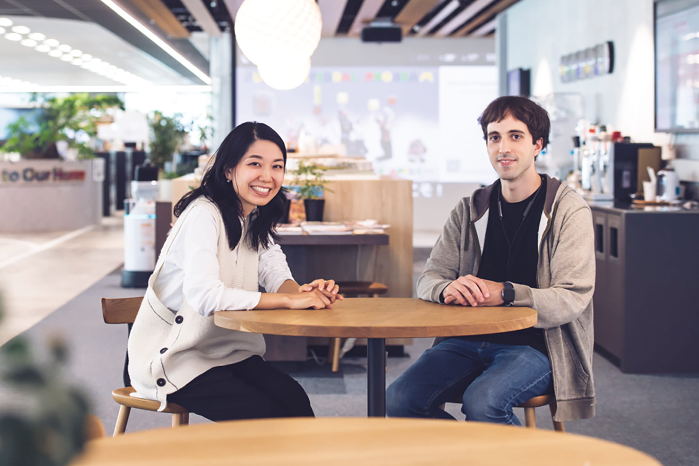 Photo of Tani and Pelaez from Woven by Toyota while talking in the office