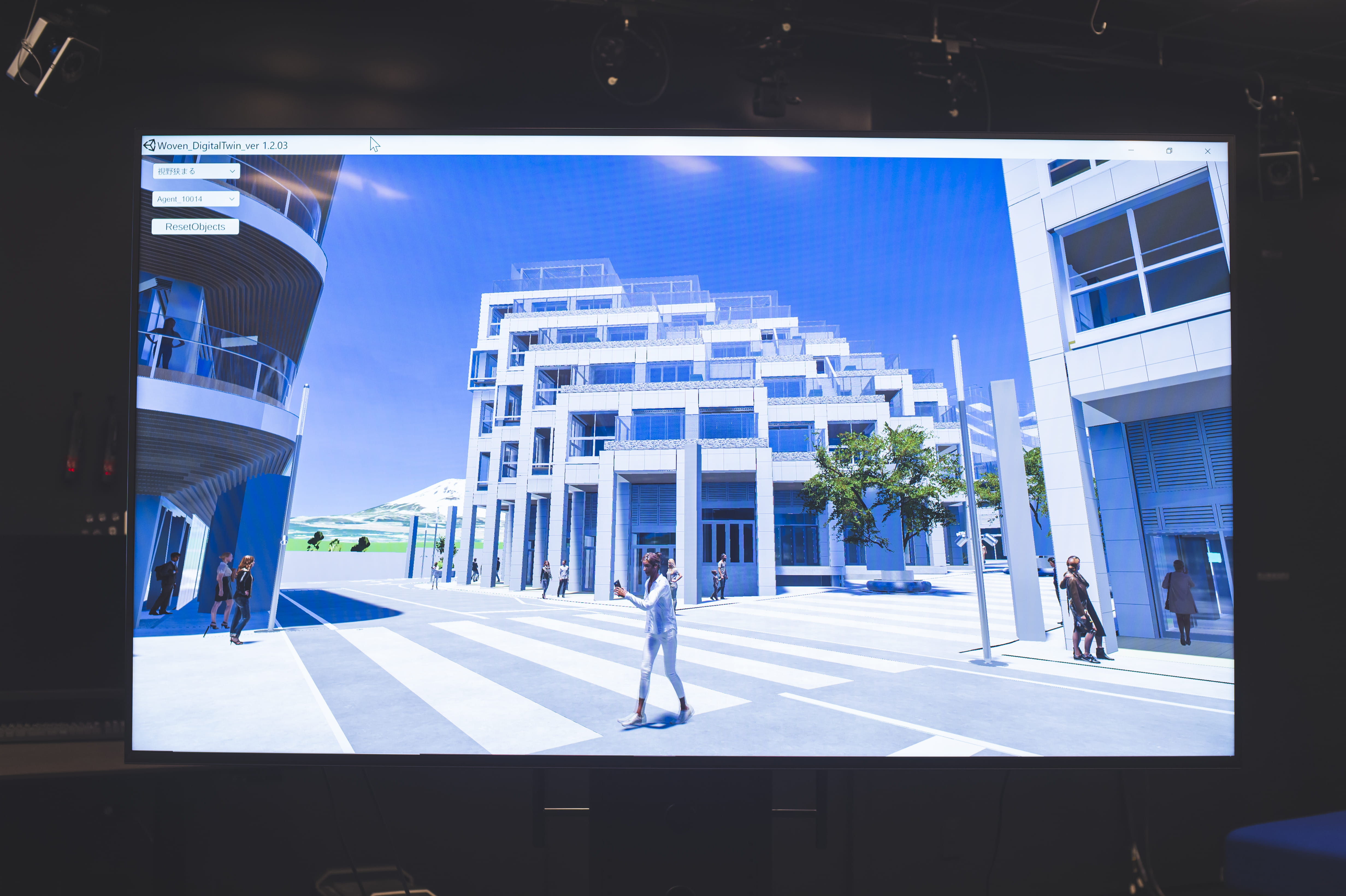 Photo of the Woven City digital twin simulating people walking around